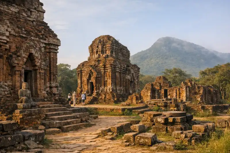 View of the iconic red brick temple ruins of My Son Sanctuary surrounded by Vietnam's green jungle