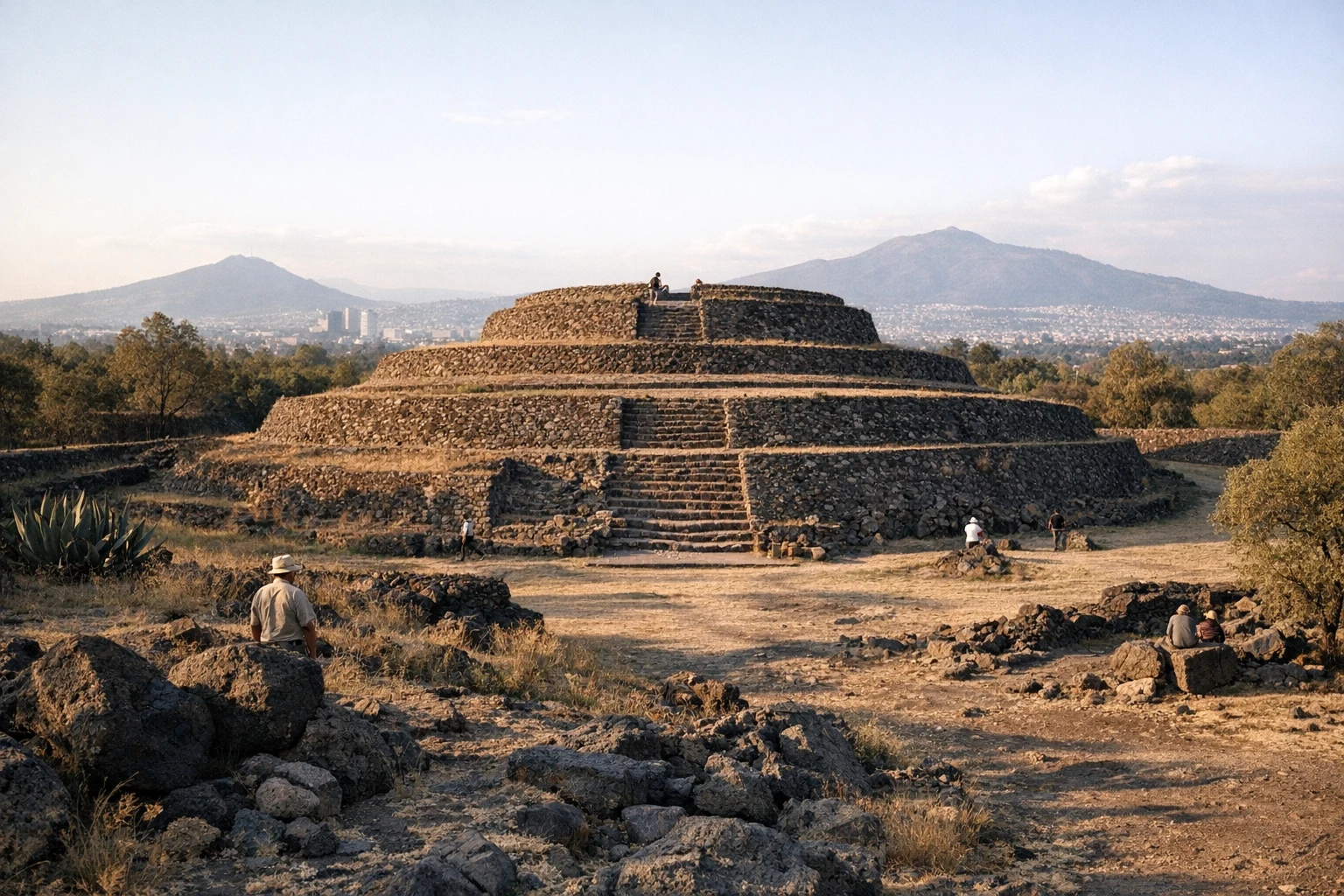 The circular pyramid of Cuicuilco in Mexico surrounded by greenery and urban Mexico City